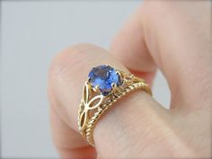 This substantial mounting has an ancient feel! The design weaves in a pattern reminiscent of old Celtics motifs. We've set the center with a luscious Tanzanite gem of the highest quality. The bright azure of this stone is the perfect mate for the watery, ocean theme of the ring! Metal: 14K Yellow Gold Gem: Tanzanite 1.14 Carats Gem Measurements: 7.7 x 5.9 mm, Oval Ring Size: 5.75 Marks: "14K(TJI)" Stamped on the inside band Tanzanite Ring, Ocean Theme, Oval Ring, Oval Rings, Red Green Yellow, Ring Metal, Yellow Gold Ring, Solitaire Engagement, Eternity Bands