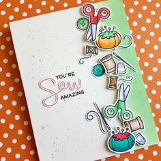 a handmade card with scissors, yarn and pumpkins on an orange tablecloth