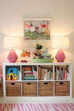 a white bookcase with baskets and lamps on top