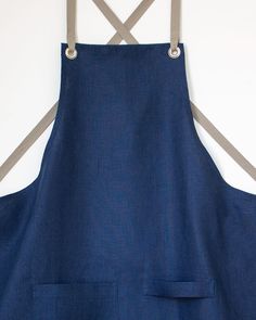 a blue apron is hanging on the wall