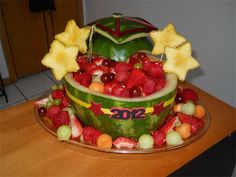 a watermelon bowl filled with fruit and stars