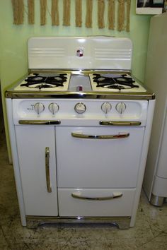 an old fashioned white stove in a kitchen