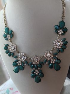 Add a touch of vintage glamour to your formal evening attire with this beautiful grass green flower and rhinestone statement necklace. The striking combination of delicate flowers and sparkling rhinestones creates a stunning piece that is sure to make a statement. Necklace Formal, Evening Accessories, Glamour Vintage, Rhinestone Statement Necklace, Delicate Flowers, Bib Necklaces, Grass Green, Green Flower, Vintage Glamour