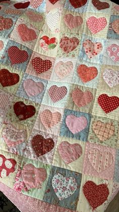 a quilted table top with many hearts on it