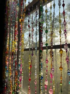 colorful beads hanging from the side of a window