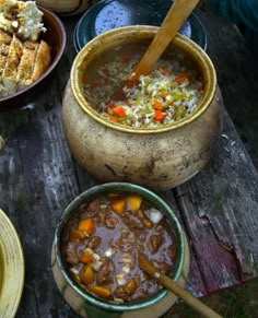 bowls of soup and bread on a picnic table