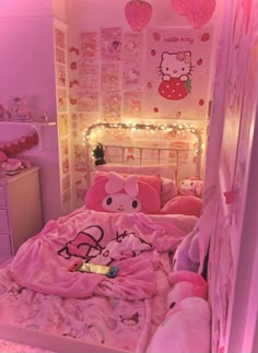 a hello kitty bedroom with pink bedding and lights on the wall, teddy bear stuffed animal