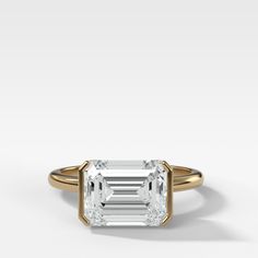 an emerald - cut diamond engagement ring in 18k rose gold