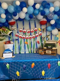 a table with balloons and fish on it