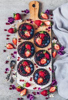 an overhead view of desserts with strawberries, blueberries and raspberries