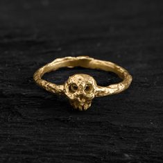 This 14k solid gold Memento Mori ring features a detailed skull with a raw, textured band, blending gothic aesthetics with timeless elegance. It's a bold statement piece, crafted to remind us of life's fleeting moments while adding an edge to your style. ◆ DIMENSIONS ◆ Skull: 7.7 x 6.5mm Ring: 2.2 x 1,5mm // 0,24" x 0,04" ◆ MATERIAL & TECHNIQUE ◆ This understated silver ring is part of our "EMBRACING CHAOS" collection, a tribute to life itself. The unexpected is around every corner, and about to Memento Mori Skull, Memento Mori Ring, Bold Statement Jewelry, Life Itself, Skull Ring, Memento Mori, Rings Statement, Statement Jewelry, Blending