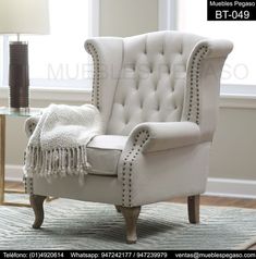 a white chair sitting on top of a rug