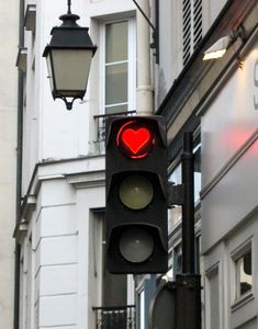 a traffic light with a red heart on it