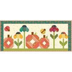 a quilted wall hanging with flowers and pumpkins on the front, along with words that read happy fall