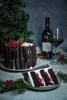 a piece of cake sitting on top of a plate next to a bottle of wine