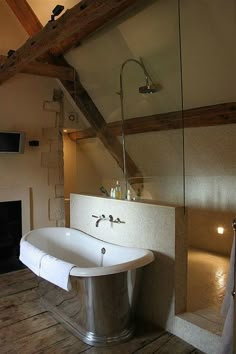 a bathroom with a bathtub and fireplace in it