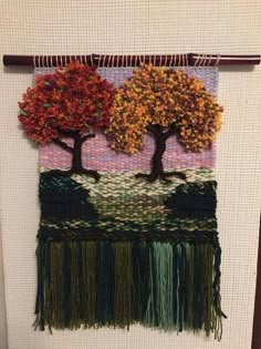 a wall hanging with two trees on it