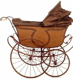 an old fashioned baby carriage with paper in it