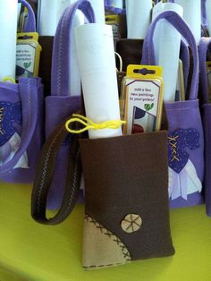 a purple bag with toothbrushes in it sitting on a table next to other items