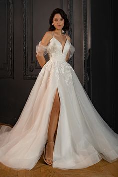 a woman in a white wedding dress posing for the camera with her legs spread out