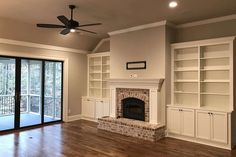 empty living room with fireplace and sliding glass doors