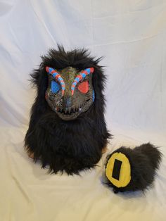 Black, Blue, and Red furred dino mask! The mask is all hand painted and sprayed with mod podge for protection! The fur is all hand and machine sewn none of it is glued! The mask can fit perfectly on a 22 inch head but could fit 21-23 inch. The tail is filled with stuffing and all hand/machine sewed If you have any questions about the mask please feel free to contact me! Handmade Black Masks And Prosthetics For Costume, Handmade Black Masks And Prosthetics For Carnival, Handmade Black Carnival Masks And Prosthetics, Handmade Full Face Black Mask, Handmade Black Masks For Costume Party, Dino Mask, Dinosaur Mask, Painting Fur, Mask Painting