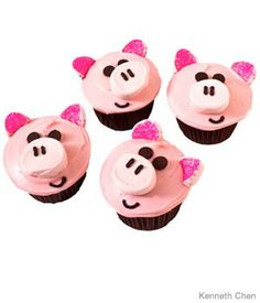 four cupcakes with pink frosting and black ears