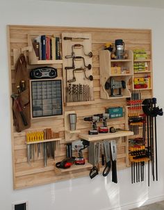 a workbench with many tools on it mounted to the side of a wall