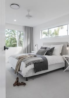 a bedroom with white walls and carpeted flooring