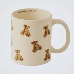 a white coffee mug with brown teddy bears on it