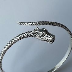 Dragon Bracelet, 925 Sterling Silver Unisex Dragon Open Cuff, Mythological Viking Bangle, Unique Bracelet Gift, Minimal Dragon Jewelry The Dragon Cuff: Ignite your power 🐉 Unleash your inner strength with our Dragon Cuff--where elegance meets power. Handcrafted from the finest Silver, this bold accessory is a symbol of resilience, wisdom, and untamed spirit.  Whether you're dressing for a special occasion or making a statement in everyday wear, the Dragon Cuff commands attention with its intric Adjustable Sterling Silver Flexible Bracelet, Flexible Sterling Silver Bracelet As Gift, Adjustable Sterling Silver Flexible Bracelets, Adjustable Flexible Sterling Silver Bracelets, Flexible Sterling Silver Bracelets, Flexible Silver Bracelets As Gift, Adjustable Symbolic Sterling Silver Bangle Bracelet, Silver Flexible Bracelet As Gift, Flexible Silver Bracelets For Gifts