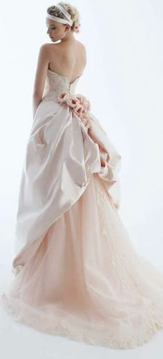 a woman in a pink wedding dress is posing for the camera