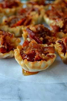 mini bacon pies are lined up on a plate