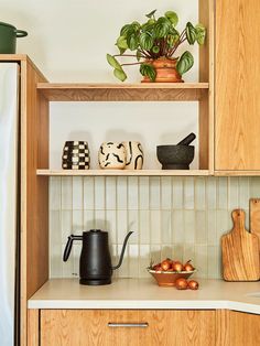 the kitchen counter is clean and ready to be used as a coffee pot, tea kettle, and other items