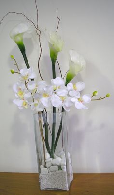 there is a vase with white flowers in it