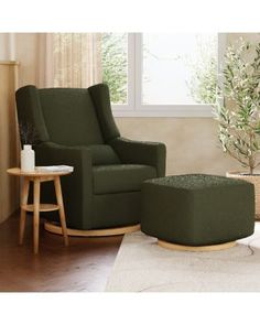 a living room with a green chair and footstool next to a small table