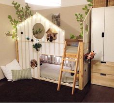 a child's room with bunk beds and green plants on the walls, along with other furniture