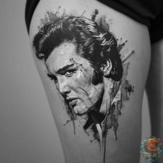 elvis presley tattoo on the back of a woman's thigh, with watercolor splashs