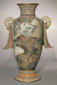 a vase with two birds painted on it's sides and gold trimmings