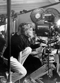 black and white photograph of woman sitting in front of camera