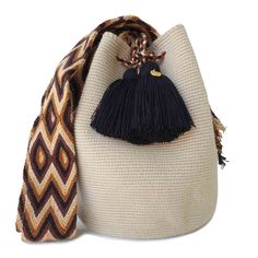 a white bag with a black tassell on it and a scarf around it