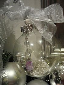 a glass ornament sitting on top of a table next to other ornaments and decorations