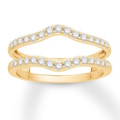 a yellow gold ring with white diamonds on the sides and an open band in the middle