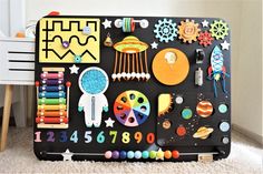 a child's play mat with various toys on it and space themed magnets