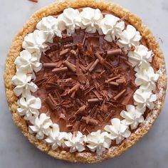 there is a chocolate pie with whipped cream on it and the words crispy rice cereal chocolate cheesecake