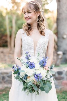 a woman in a wedding dress holding a bouquet