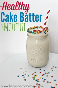 a mason jar filled with cake batter and sprinkles next to a sign that says healthy cake batter smoothie