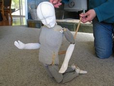 a person is making a doll out of an old mannequin's body