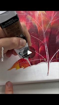 someone is painting a red flower with acrylic paint on the paper and then using it