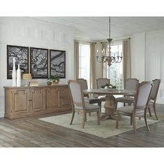 a dining room table with chairs and a chandelier